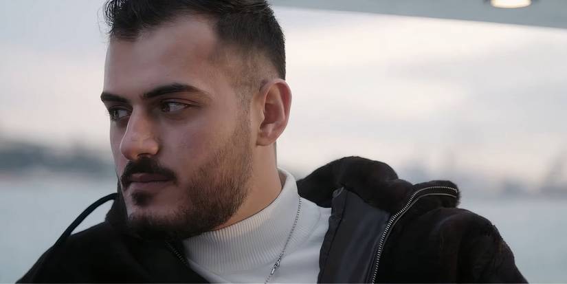 Adnan in 90 Day Fiance Before the 90 Days looking angrily at Tigerlily wearing black jacket and white turtleneck