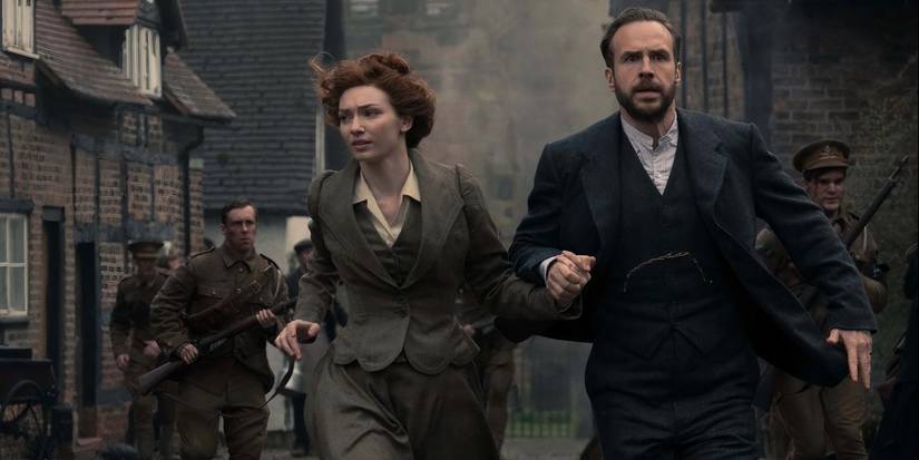 Amy (Eleanor Tomlinson) and George (Rafe Spall) running with soldiers from explosions in The War of the Worlds.
