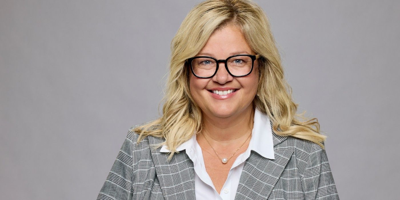 Angela Murray from Big Brother 26 smiling in front of a gray background.