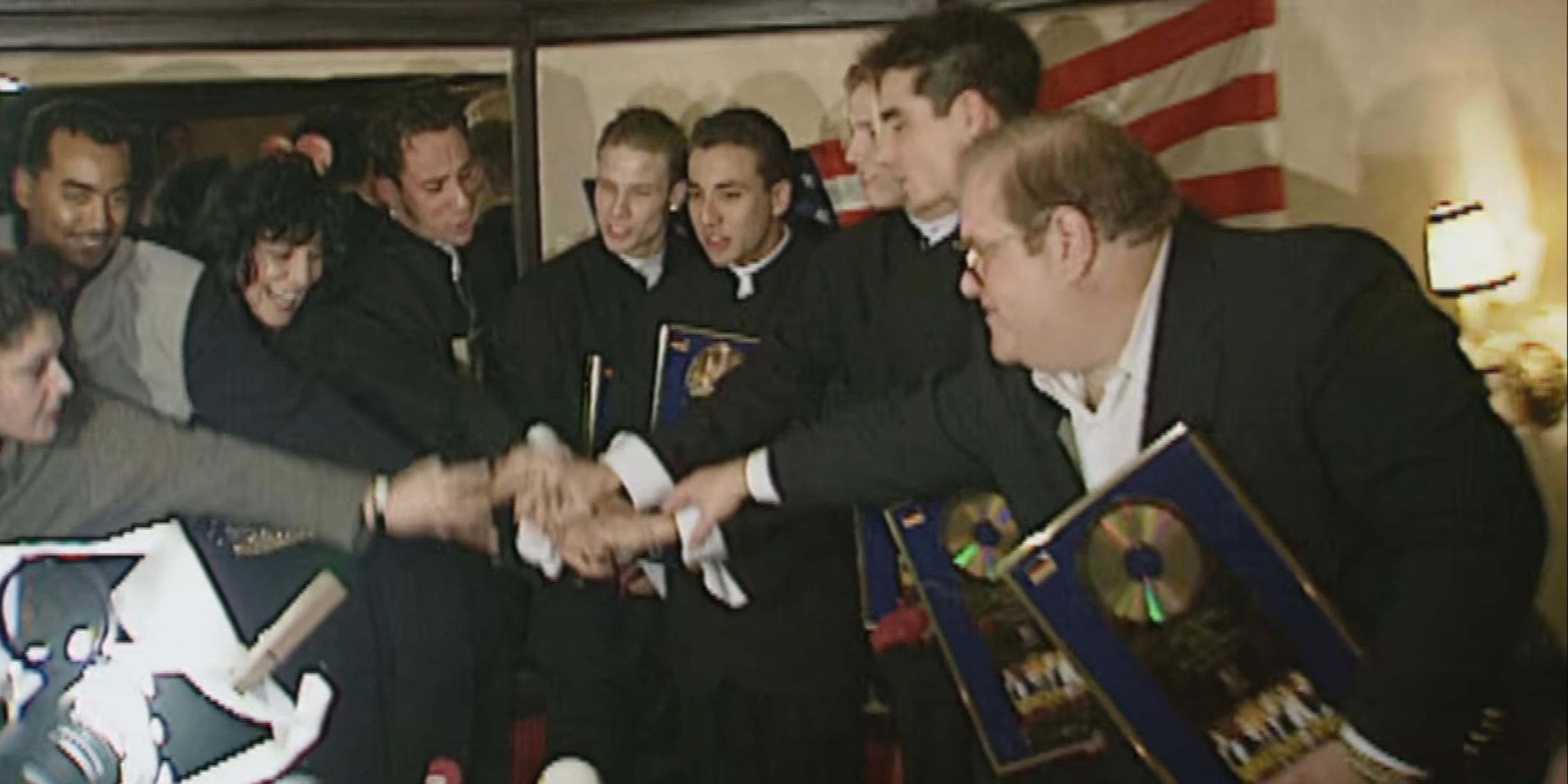 Footage Of The Backstreet Boys And Lou Pearlman Accepting The Achievement Of a Gold Record From BMG In Dirty Pop: The Boy Band Scam