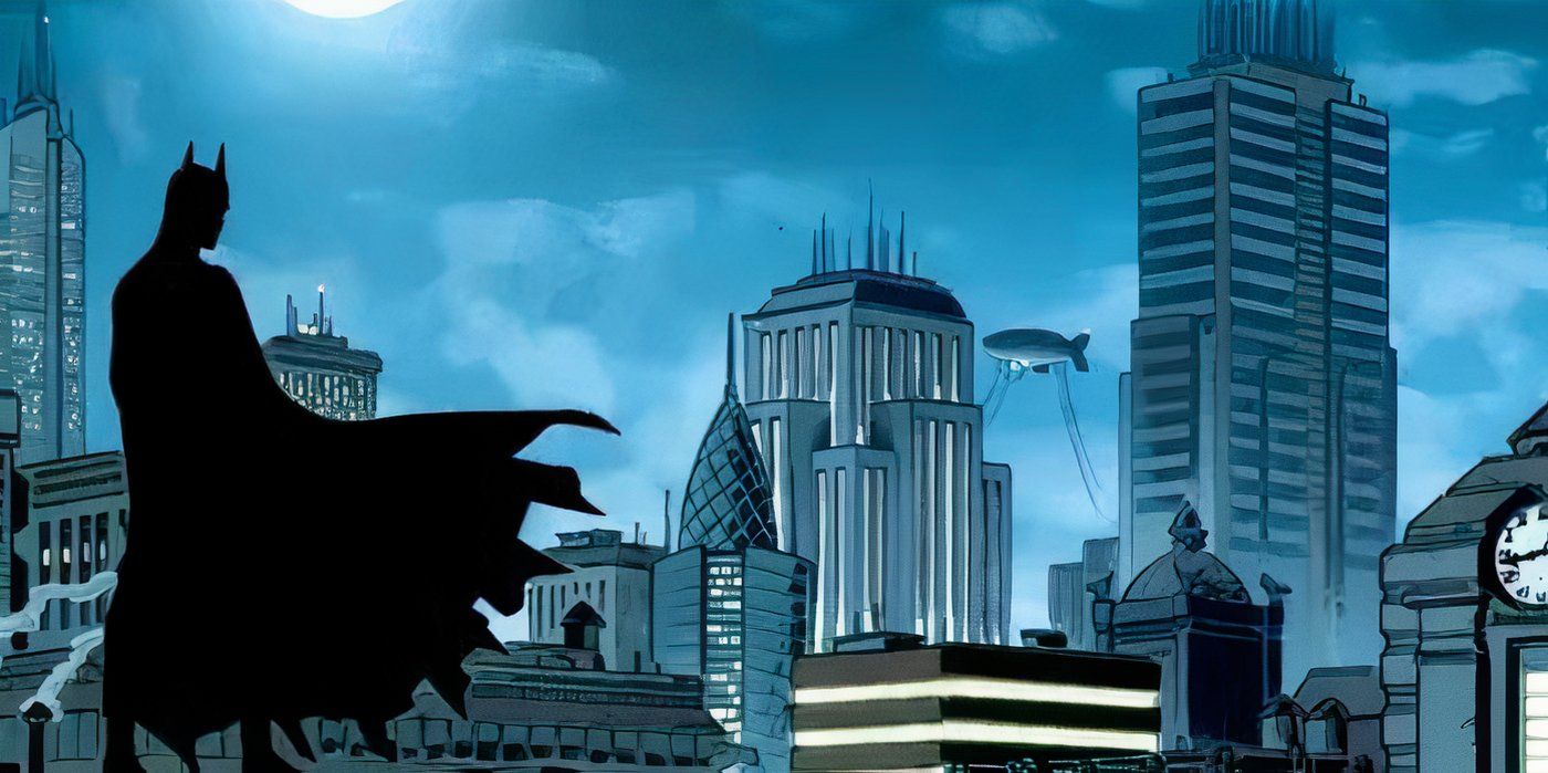 Batman stands atop a building looking out across Gotham City. It is night, the sky a deep blue and cloudy.