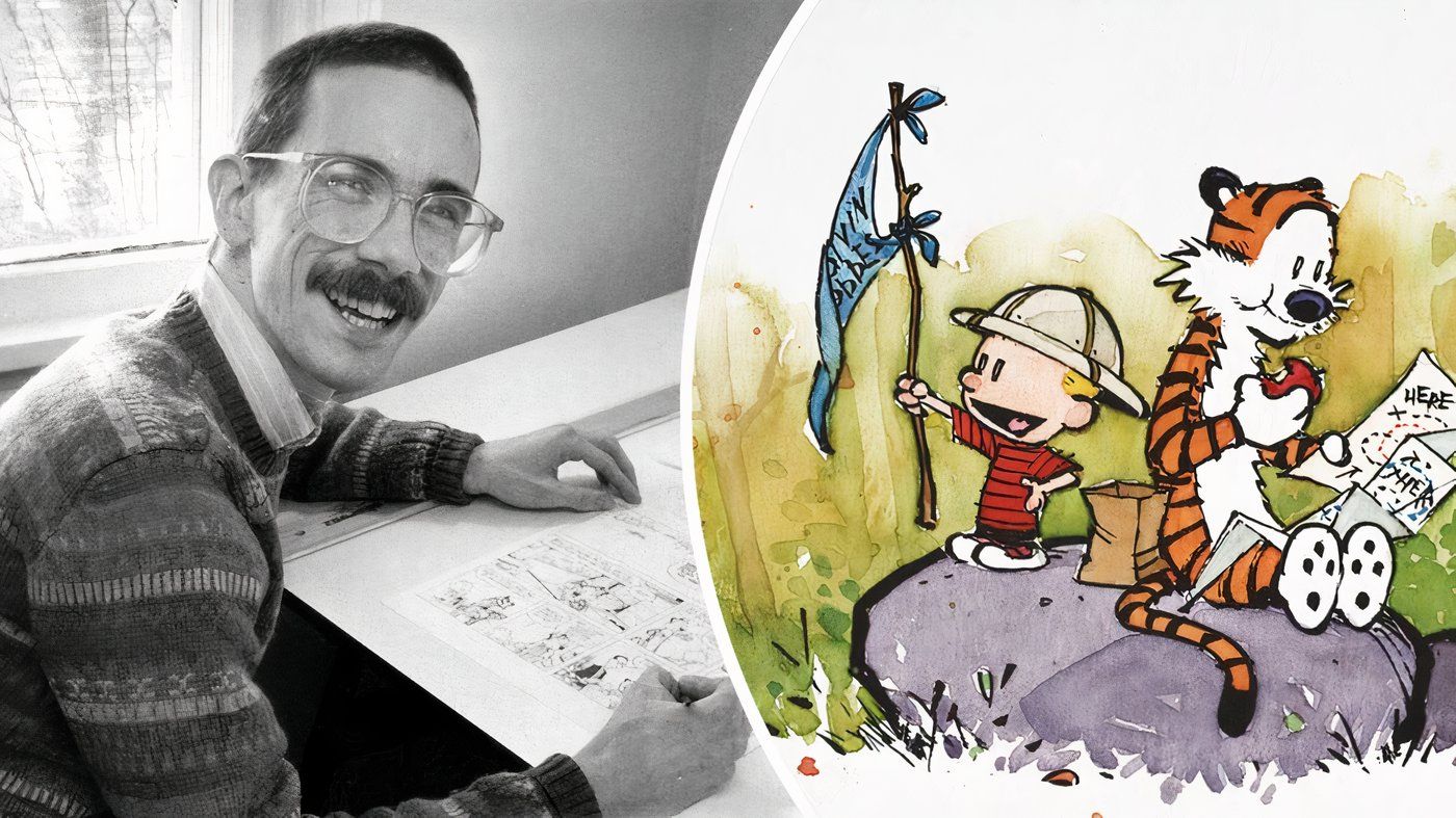 Bill Watterson drawing at his desk with a picture of Calvin and Hobbes next to him.