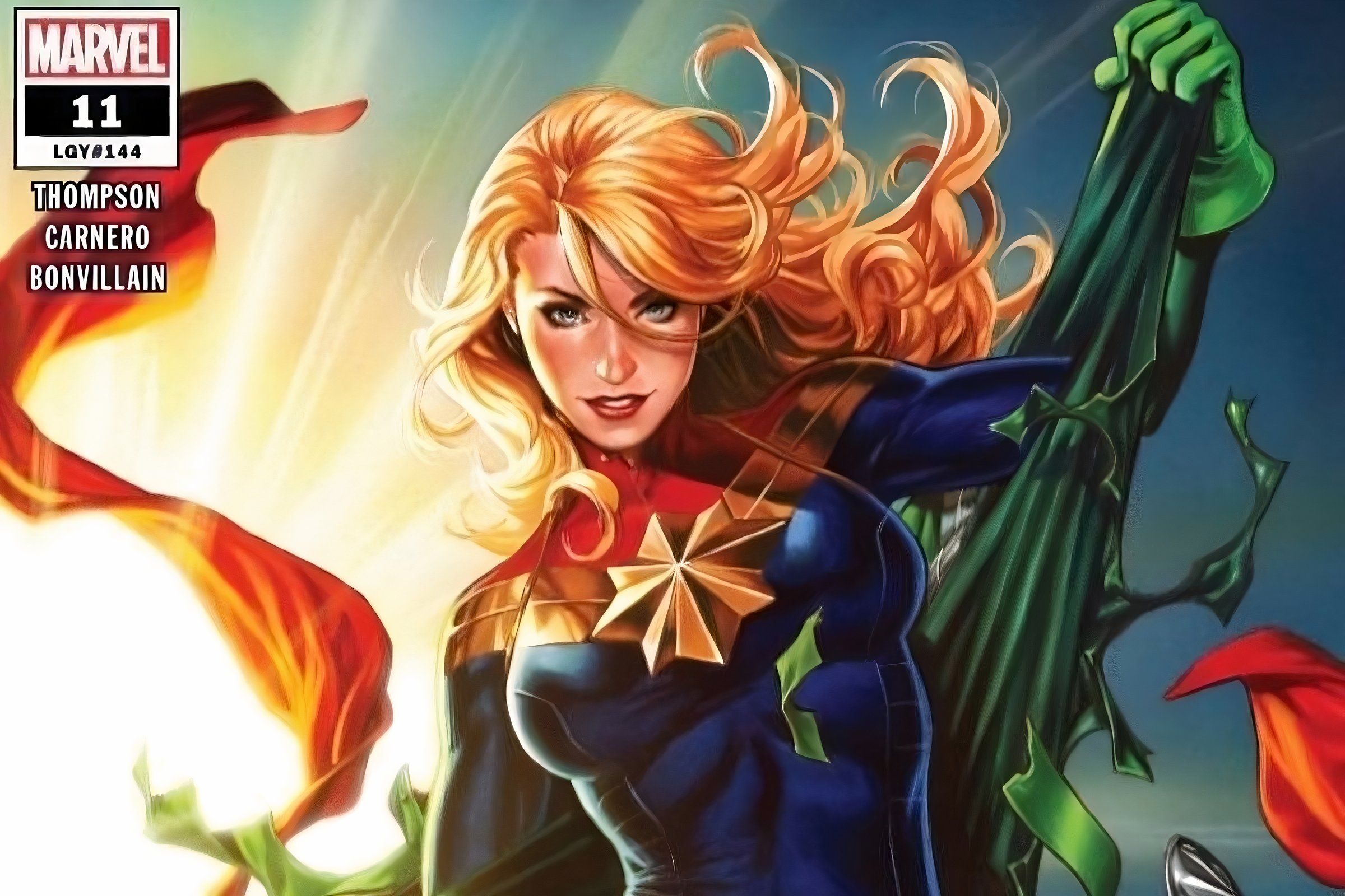 Captain Marvel rips off her old suit to reveal her iconic look.