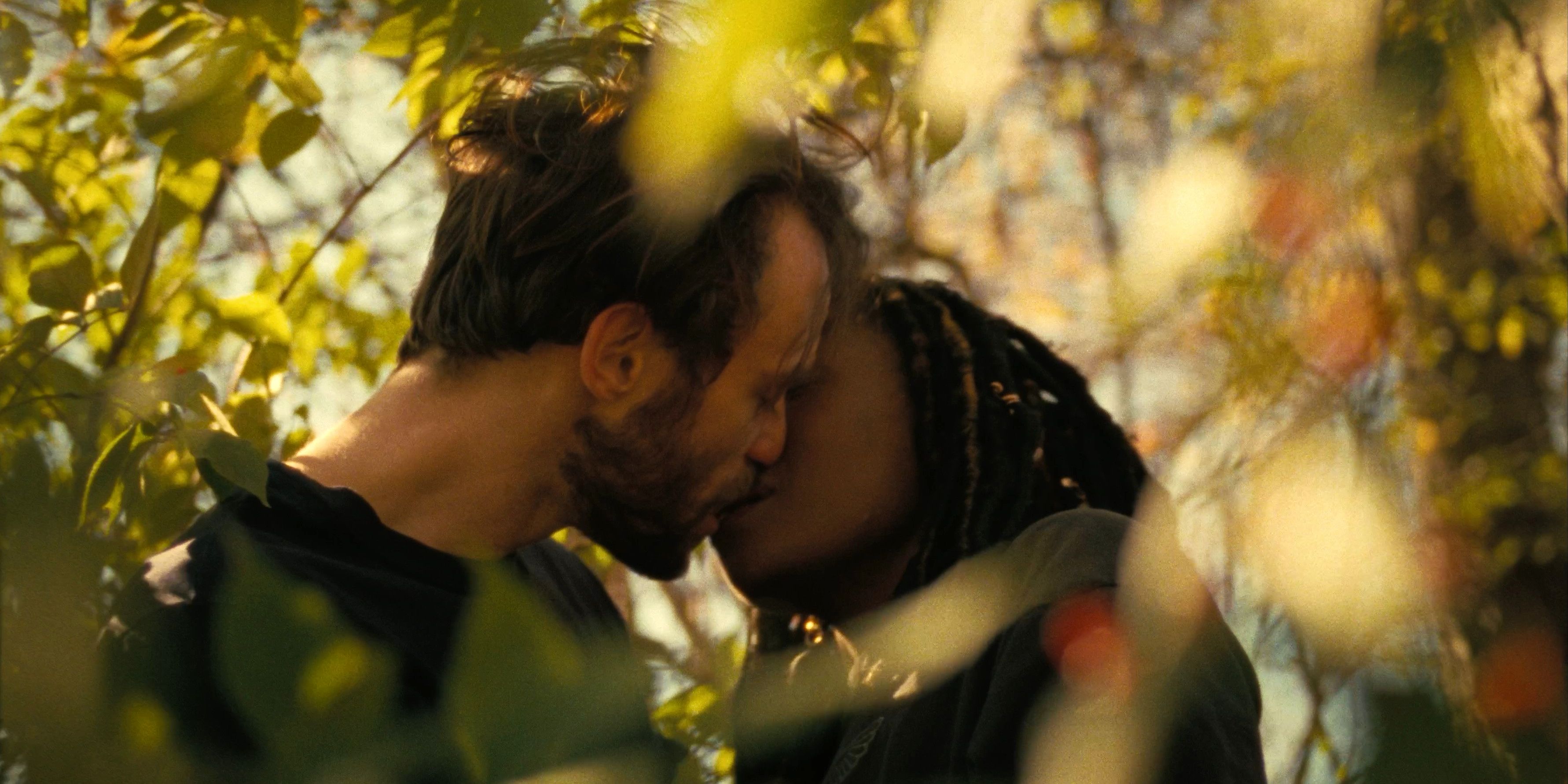 Casey and Dandelion kissing surrounded by yellow leaves in Dandelion