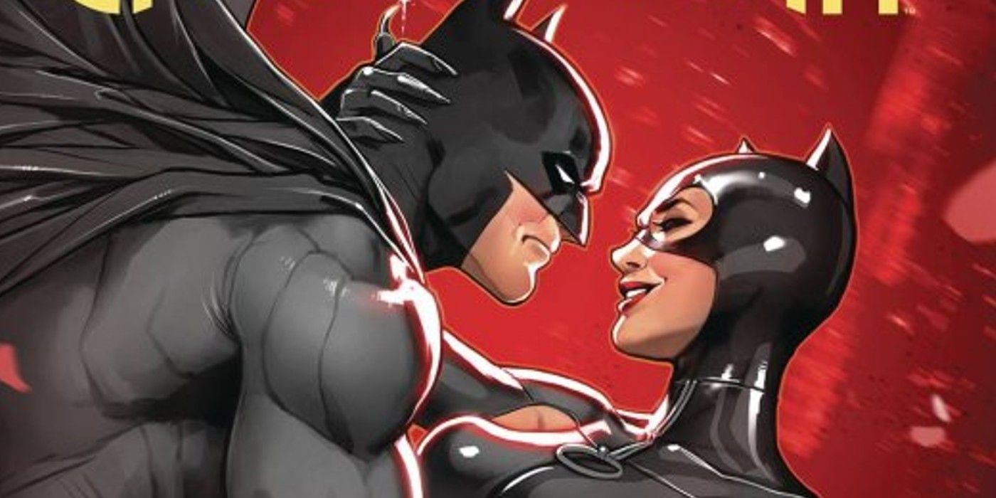 Catwoman and Batman hold onto one another against a red backdrop.
