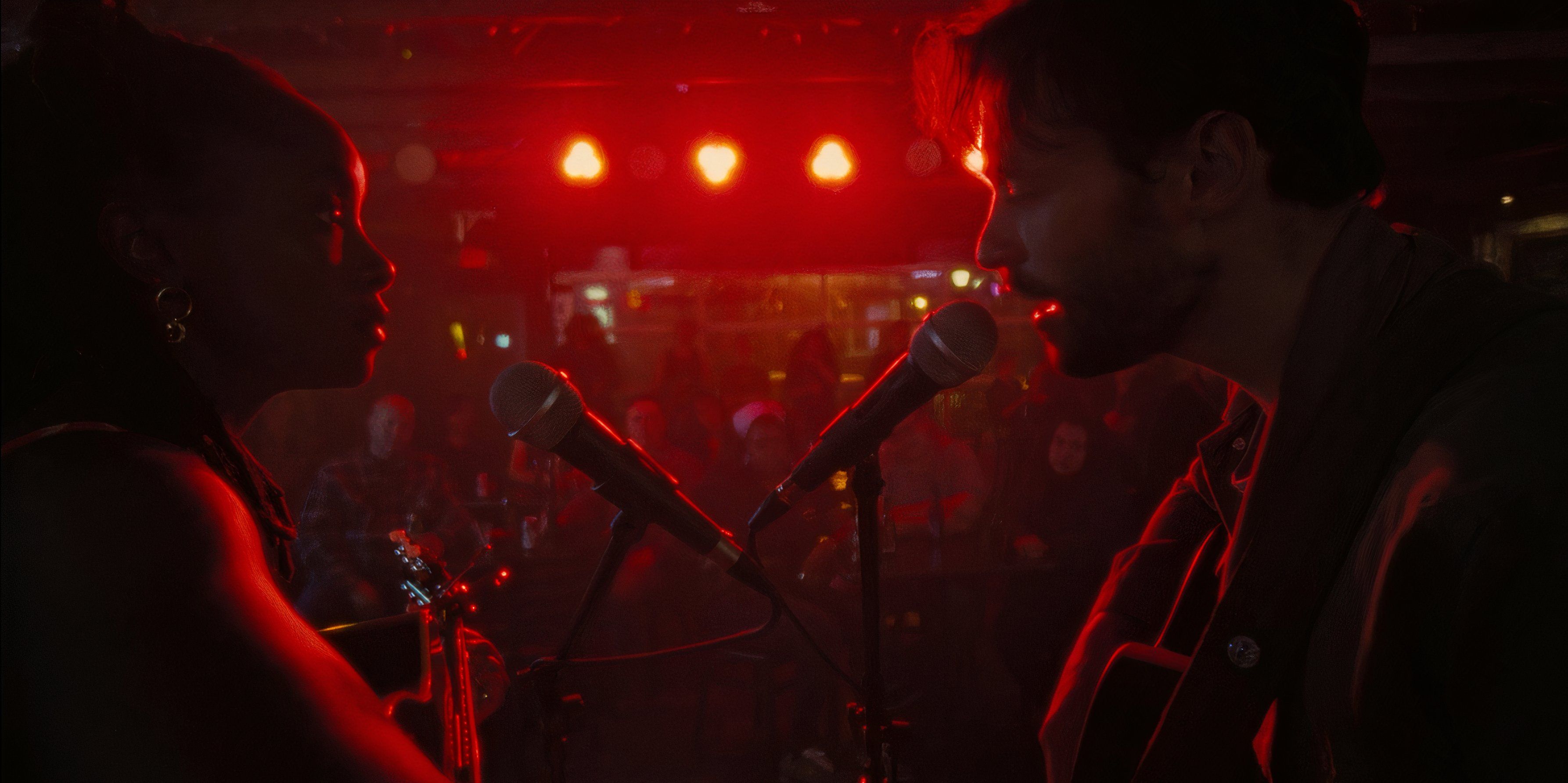 Dandelion and Casey facing each other as they perform on stage in Dandelion