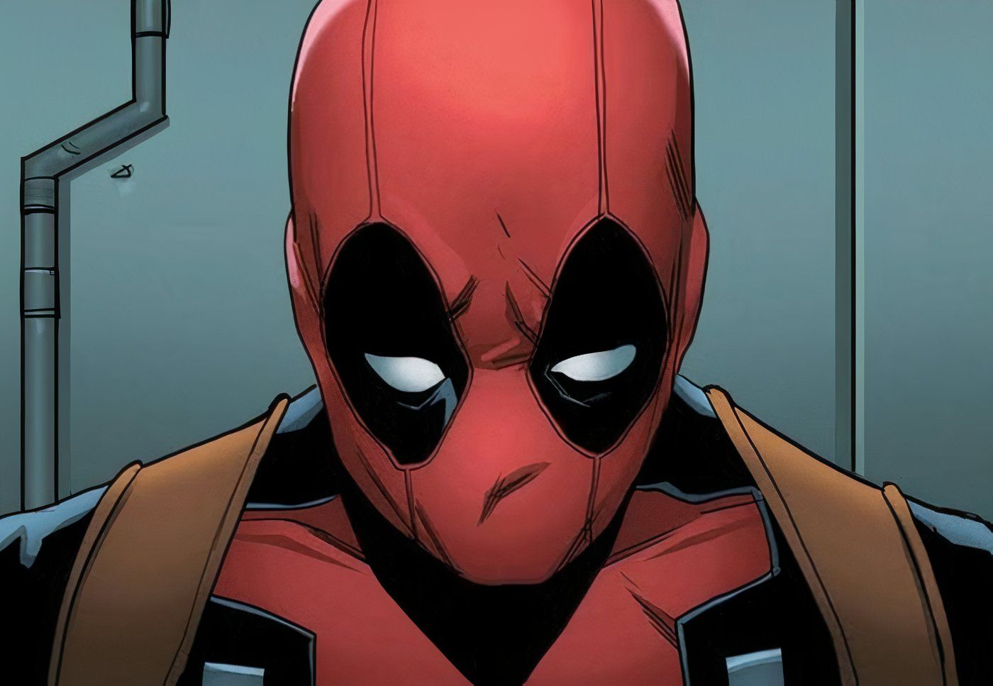 Close-up of Deadpool's masked face looking down, sad.