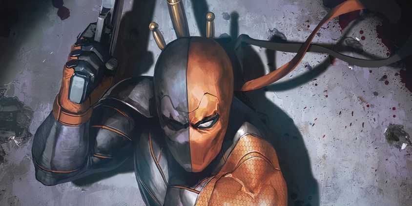 Close up of Deathstroke backed against a concrete wall, holding a gun in one hand.