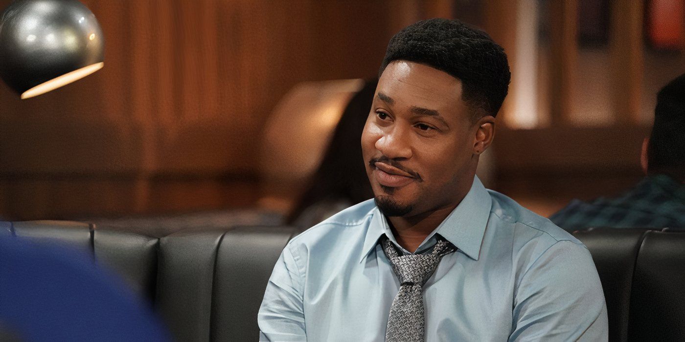 Aaron Jennings smiles while listening to someone talk at a restaurant