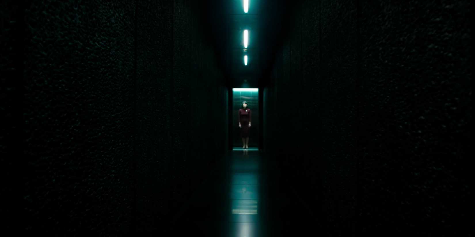 Dichen Lachman as Ms Casey standing in the elevator to the Testing Floor in Severance season 1-1