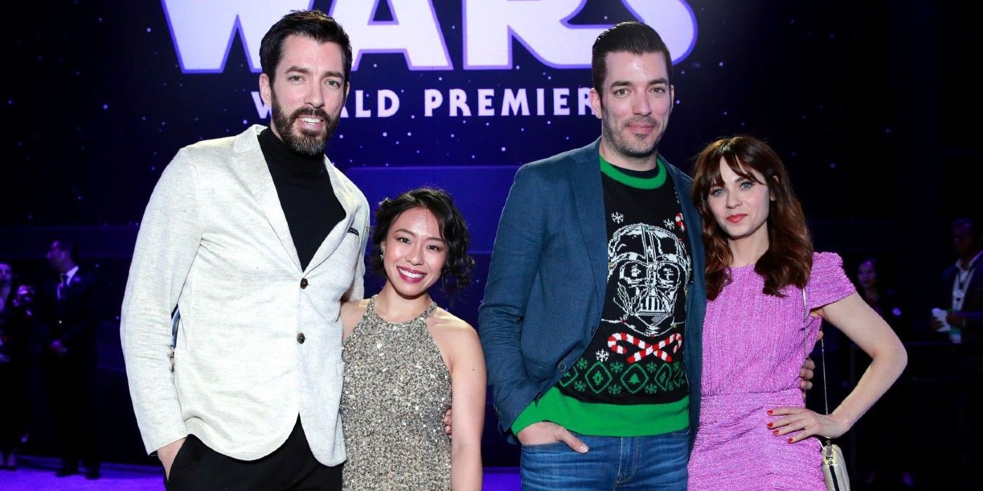 Drew Scott e Linda Phan posando ao lado de Jonathan Scott e Zooey Deschanel em um tapete vermelho.