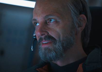 Ed Baldwin looking pleased wearing a headseat in For All Mankind season 4