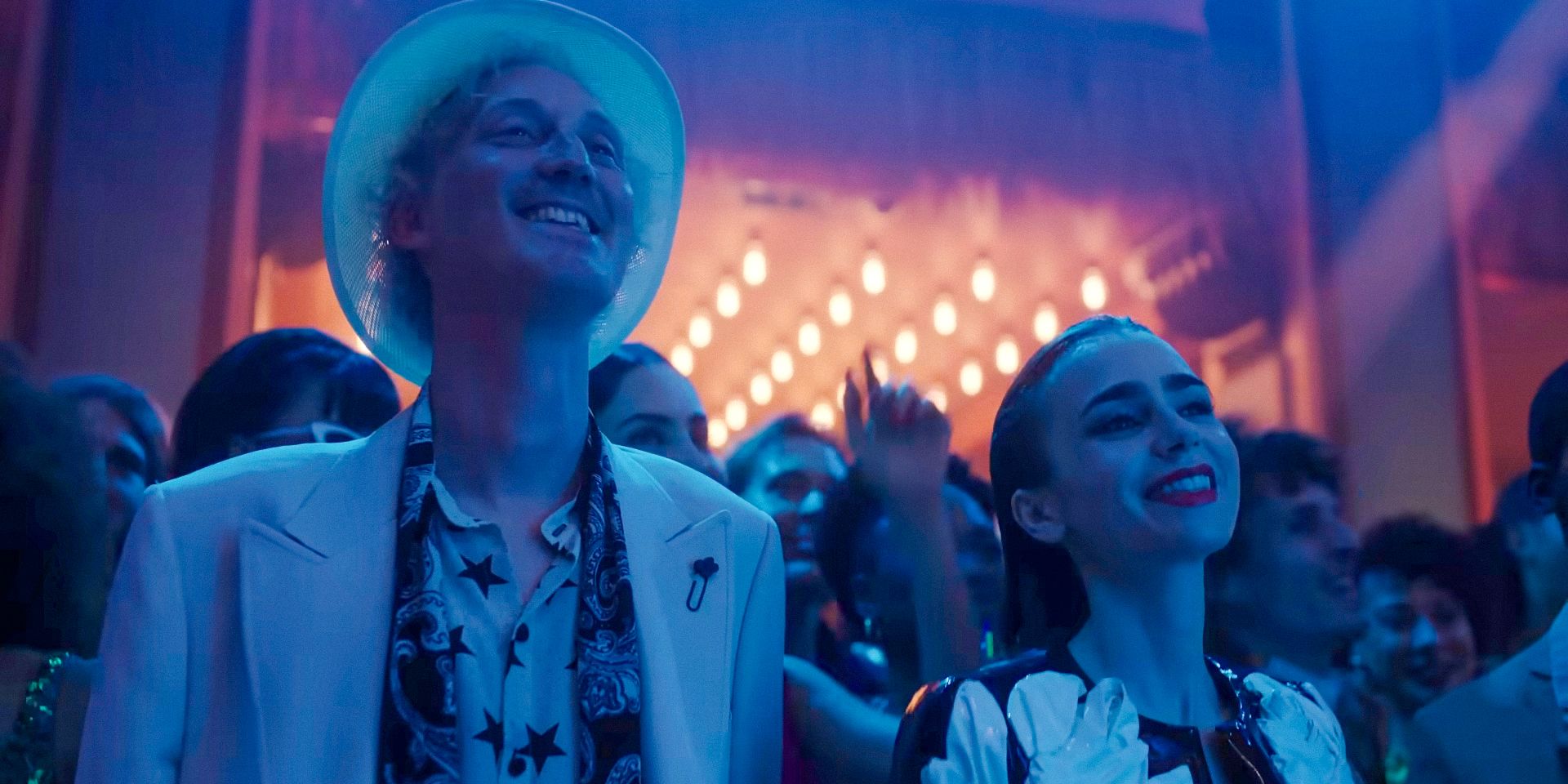 Luc (Bruno Gouery) and Emily (Lily Collins) among the audience at Mindy's concert in Emily in Paris season 4