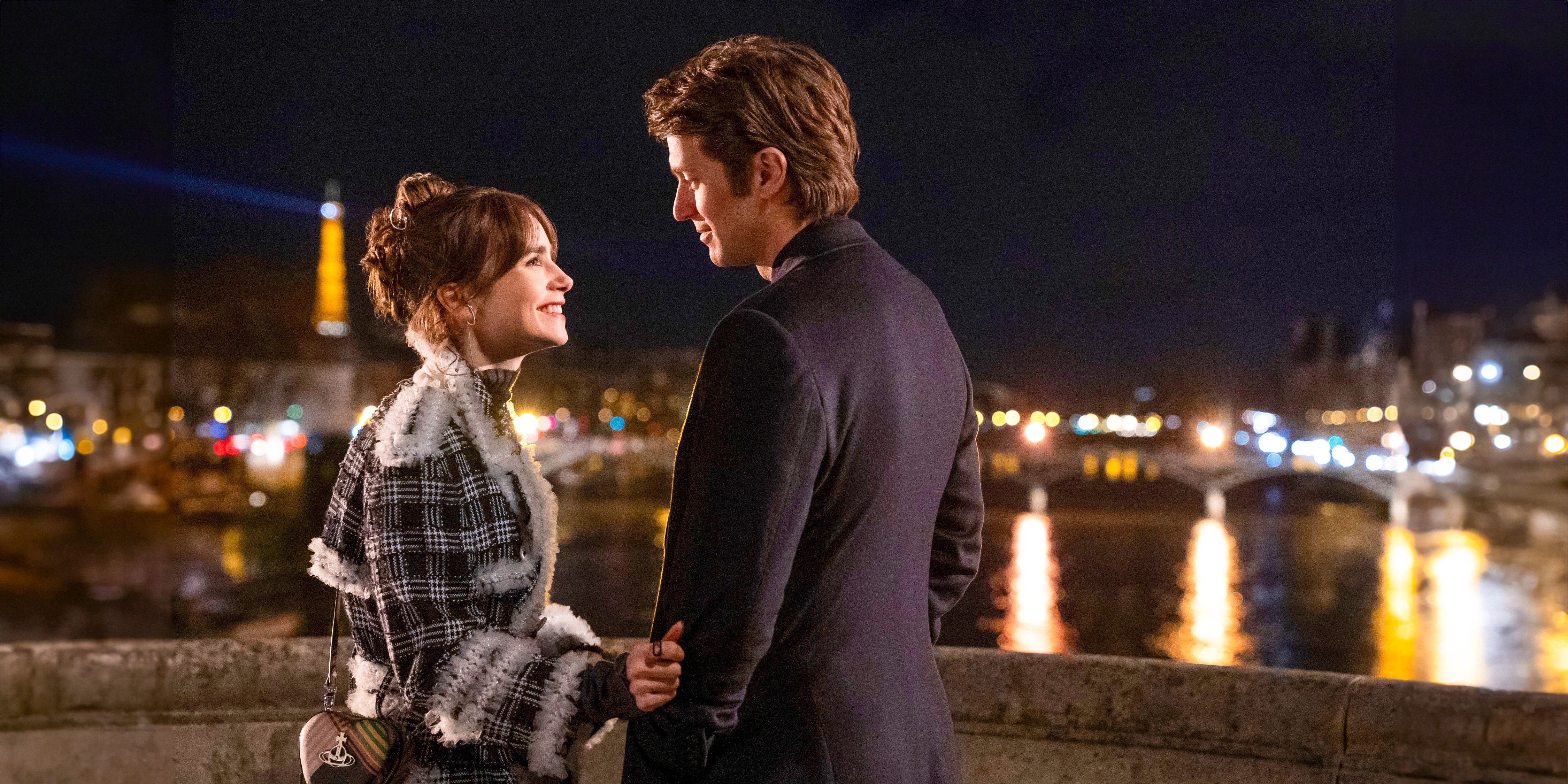 Emily (Lily Collins) and Gabriel (Lucas Bravo) looking into each other's eyes with the Eiffel Tower in the background in Emily in Paris season 4