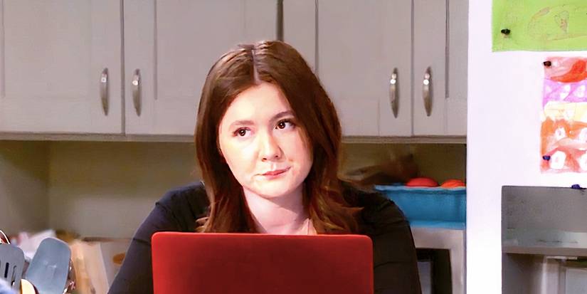 Emma Kenney's Harris frowns at the kitchen table in The Conners season 6 episode 13