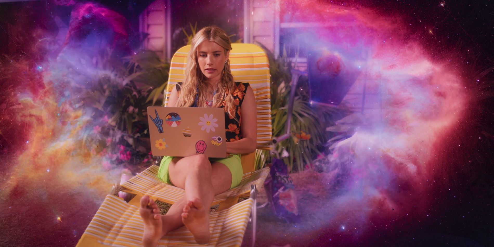 Emma Roberts As Rex Simpson Sitting On Pool Chair With Computer In Lap & Galaxy Background Behind Her In Space Cadet.jpg