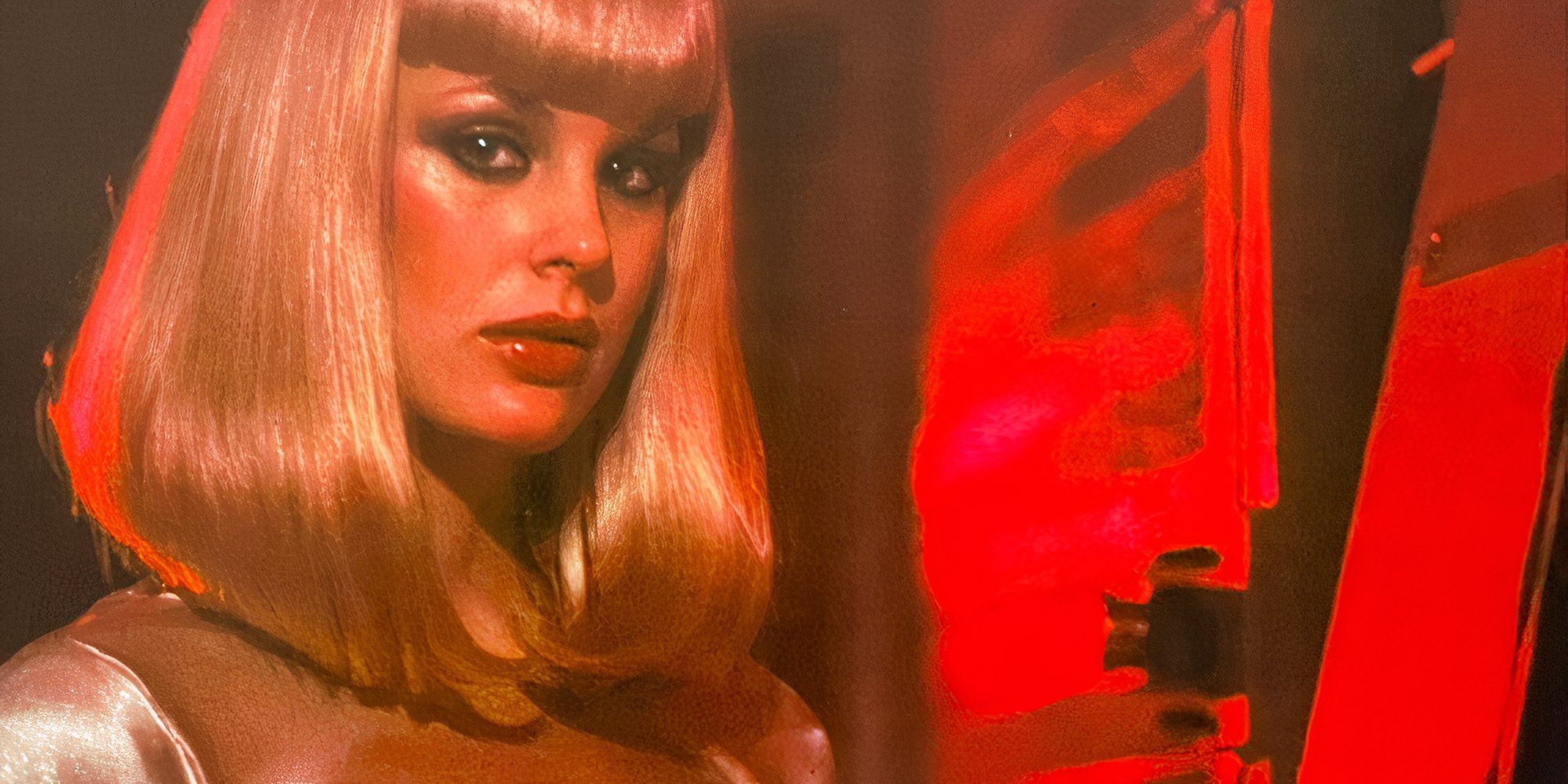 Galaxina in red with a serious expression