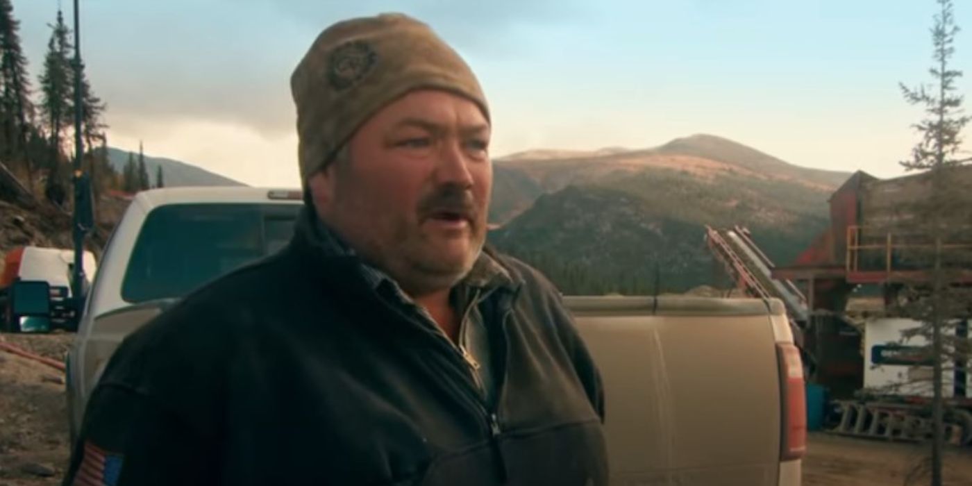 Gene Cheeseman standing in front of his truck in Gold Rush.