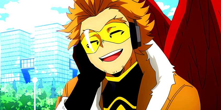 The former number 2 Hero, Hawks, smiles with his eyes closed. Behind him, a city can be seen.