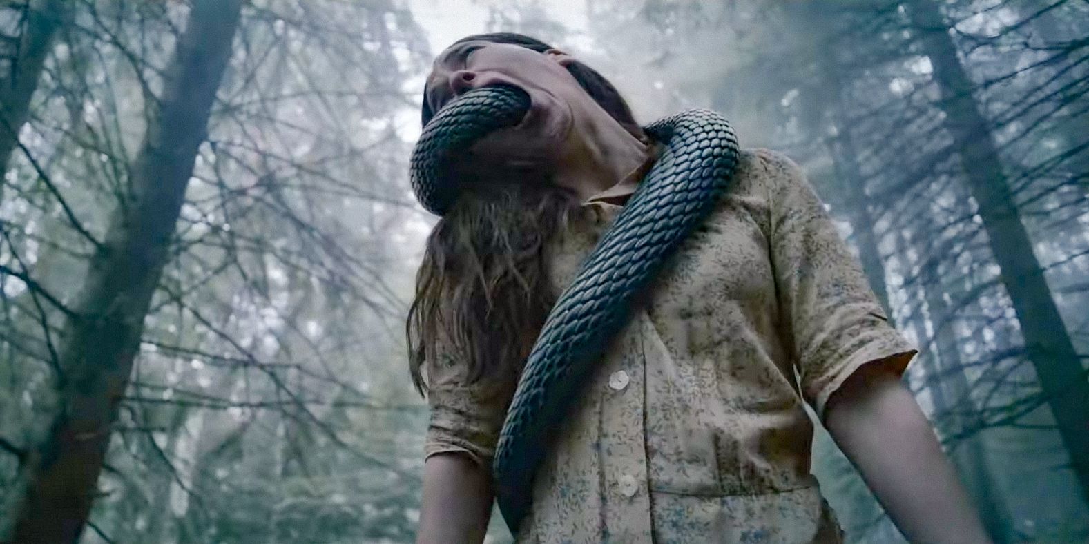 A woman with a snake coming out of her mouth in the middle of the forest in Hellboy: Crooked Man