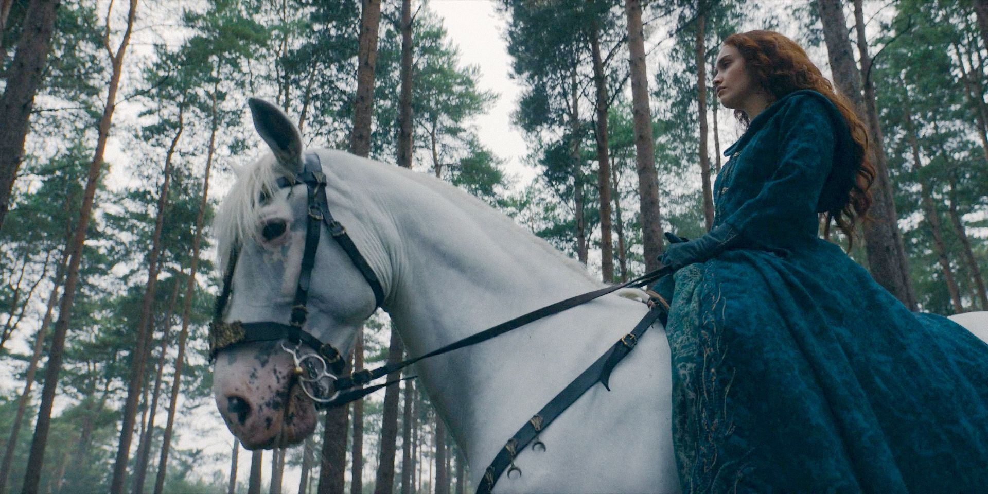 Alicent (Olivia Cooke) riding a horse through the dense forest in House of the Dragon Season 2 Episode 7