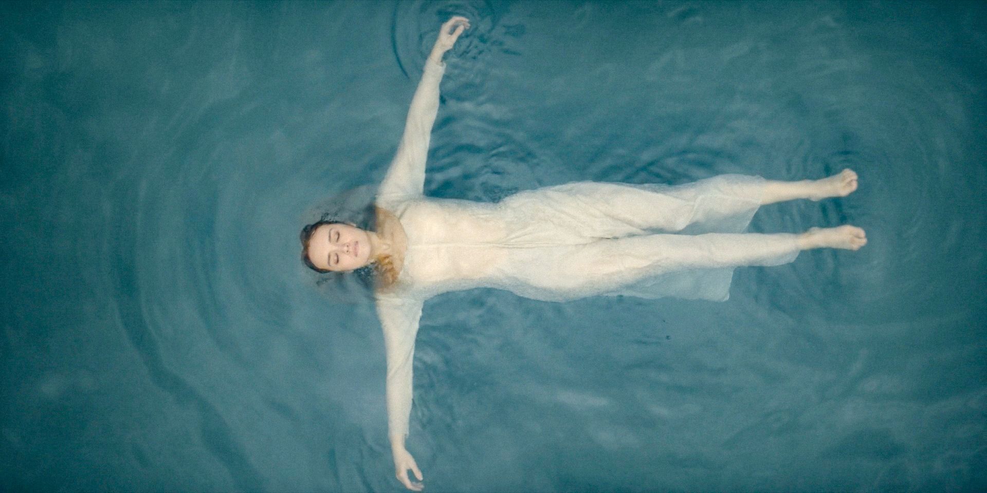 Alicent (Olivia Cooke) is thoughtfully floating in a lake in House of the Dragon Season 2 Episode 7