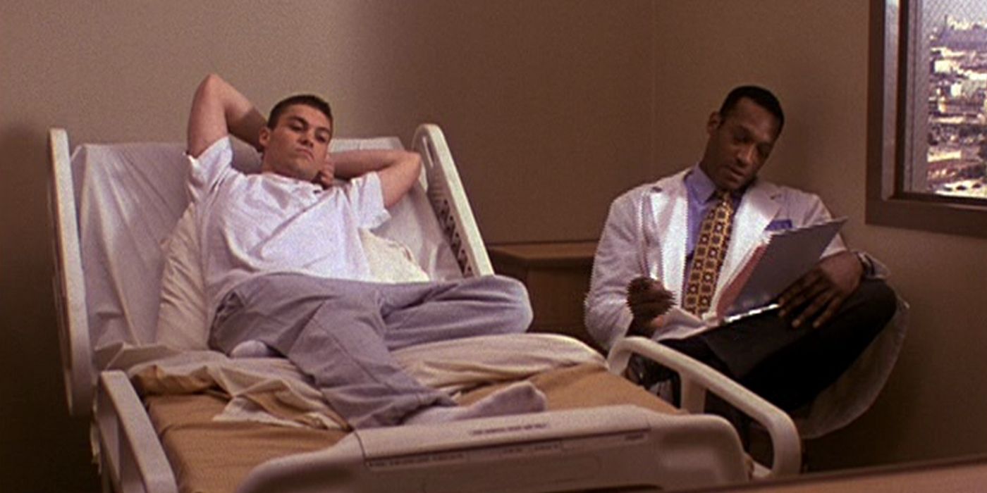 David Silver (Brian Austin Green) in a hospital bed being monitored by a doctor in Beverly Hills 90210
