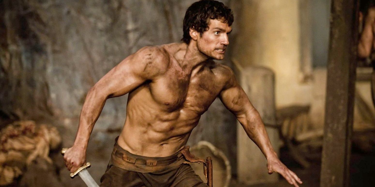 Theseus (Henry Cavill) shirtless, wielding a sword, and looking crazed in Immortals