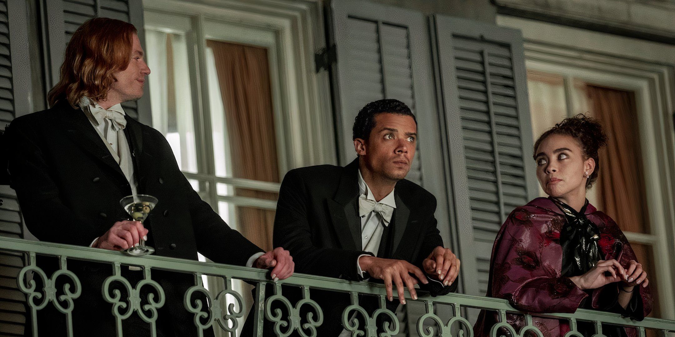 Louis (Jacob Anderson), Lestat (Sam Reid) and Claudia (Bailey Bass) stand on their New Orleans balcony in Interview With The Vampire season 1