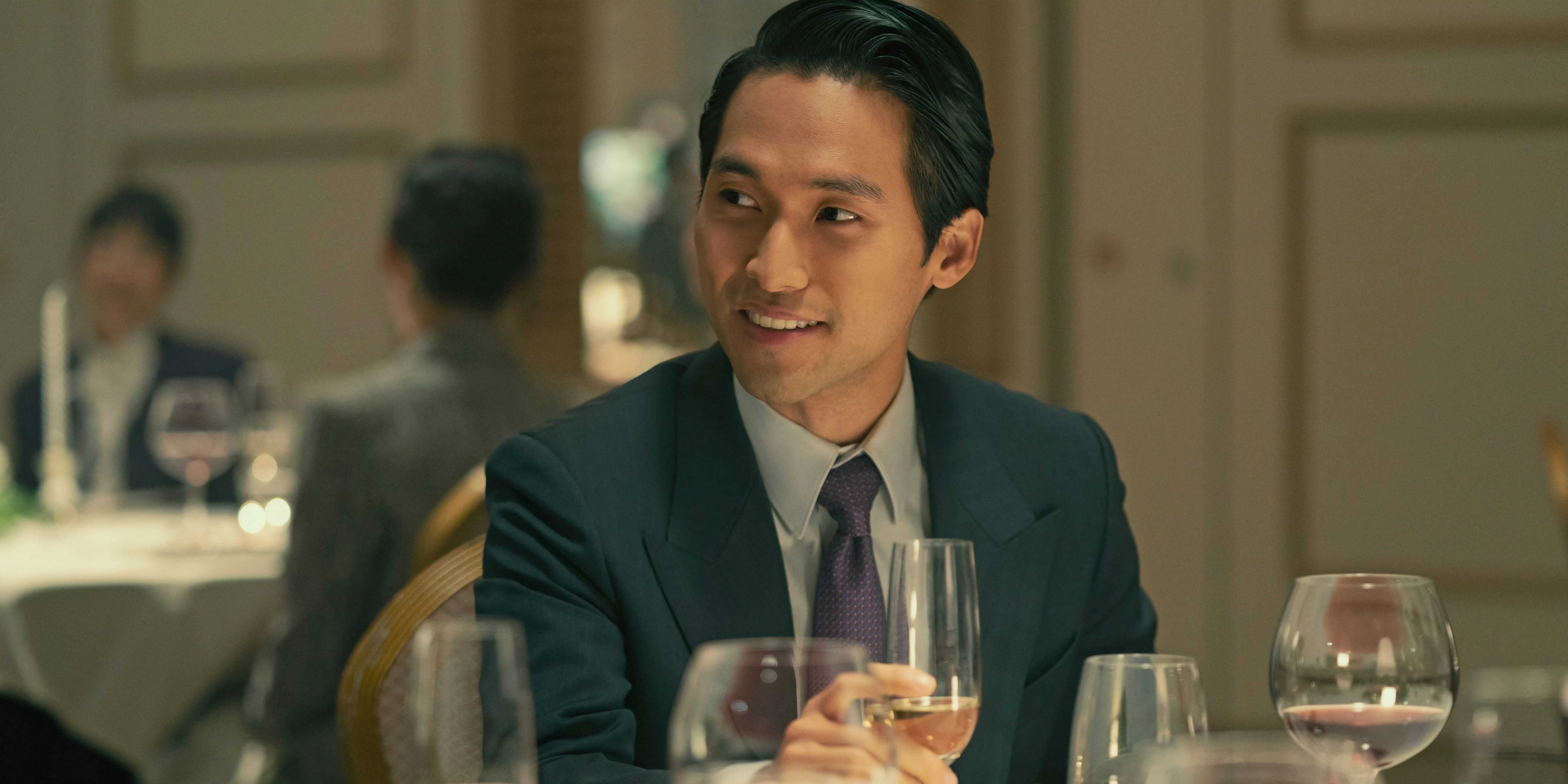 Jin Ha as Solomon at a fine dining restaurant in Pachinko