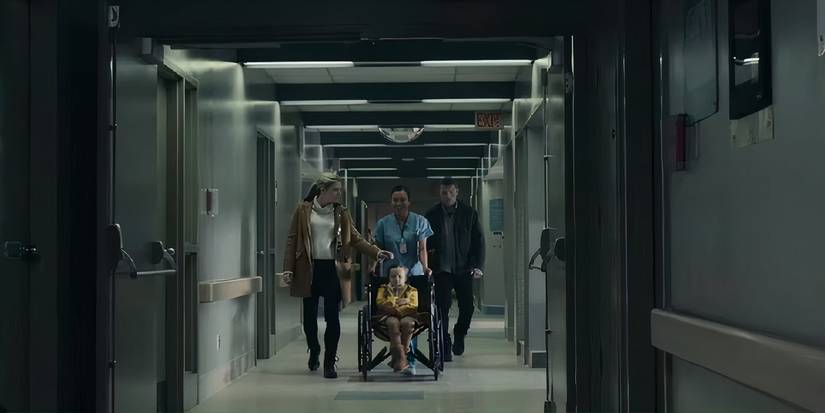 Joanne (Lily Rabe) and Ray (Sam Worthington) wheeling Peri (Lucy Capri) at the hospital after she suffers an injury