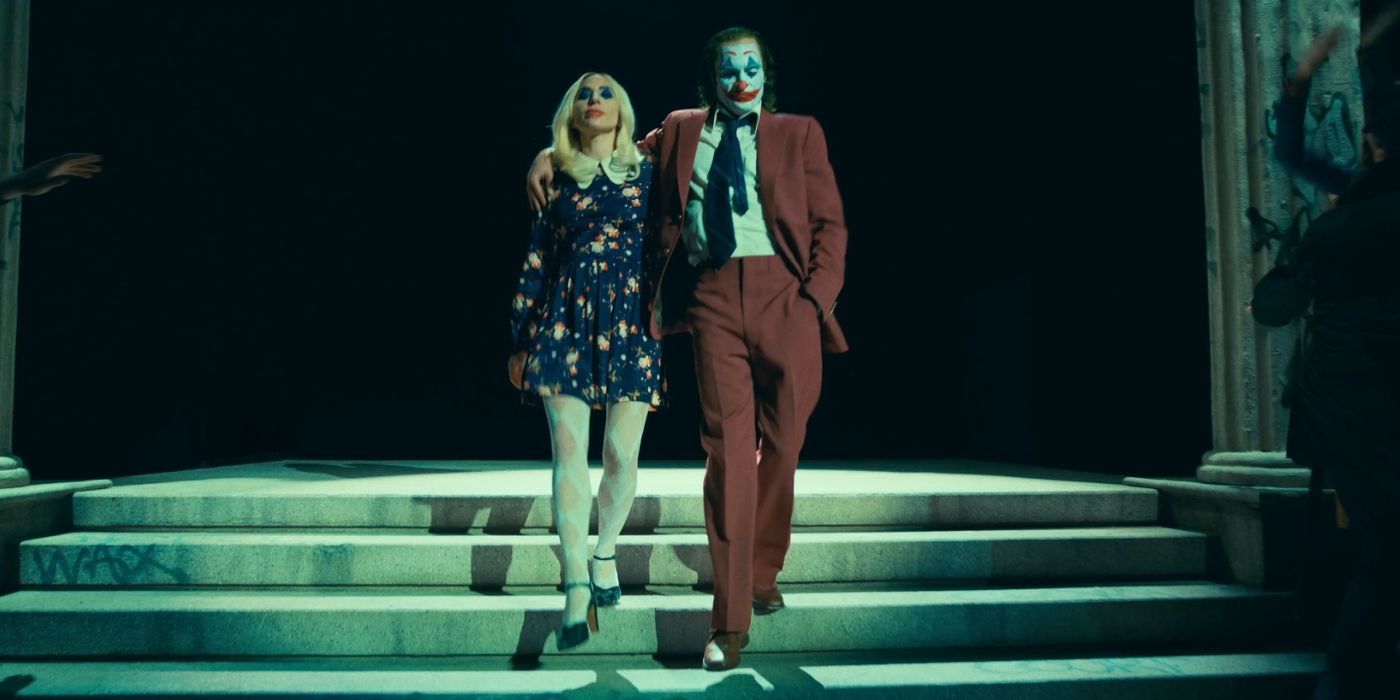 Joaquin Phoenix as Joker and Lady Gaga as Harley Quinn climbing stairs in Joker Folie à Deux