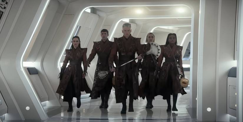 La'an (Christina Chong), Spock (Ethan Peck), Pike (Anson Mount), Chapel (Jess Bush), and Uhura (Celia Rose Gooding) as Vulcans stride down the hallway Strange New Worlds