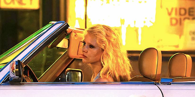 Mia Goth's Maxine sits in her car in MaXXXine