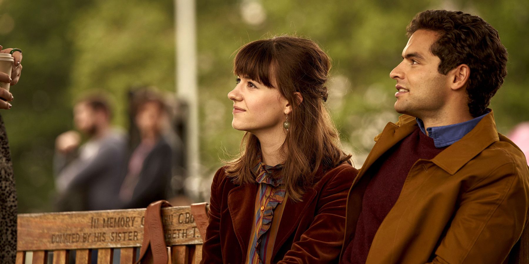 Daisy Edgar-Jones sitting on a bench in Normal People 