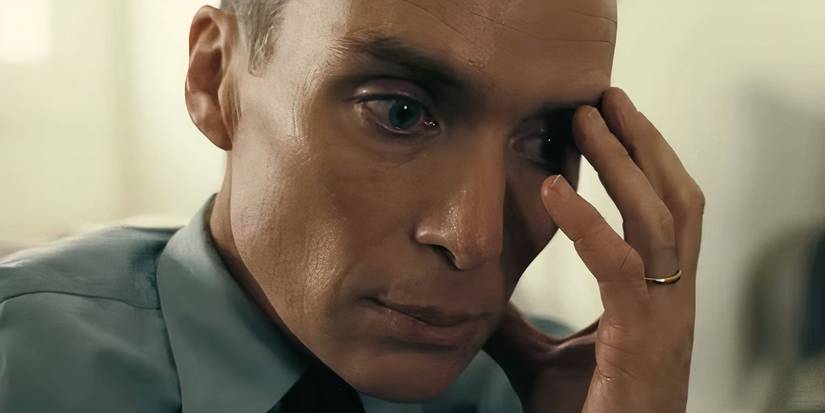 Oppenheimer holds his hand to his face in Oppenheimer