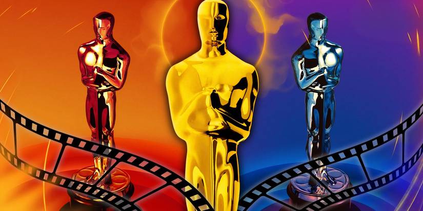Three Oscar statuettes stand in a line.