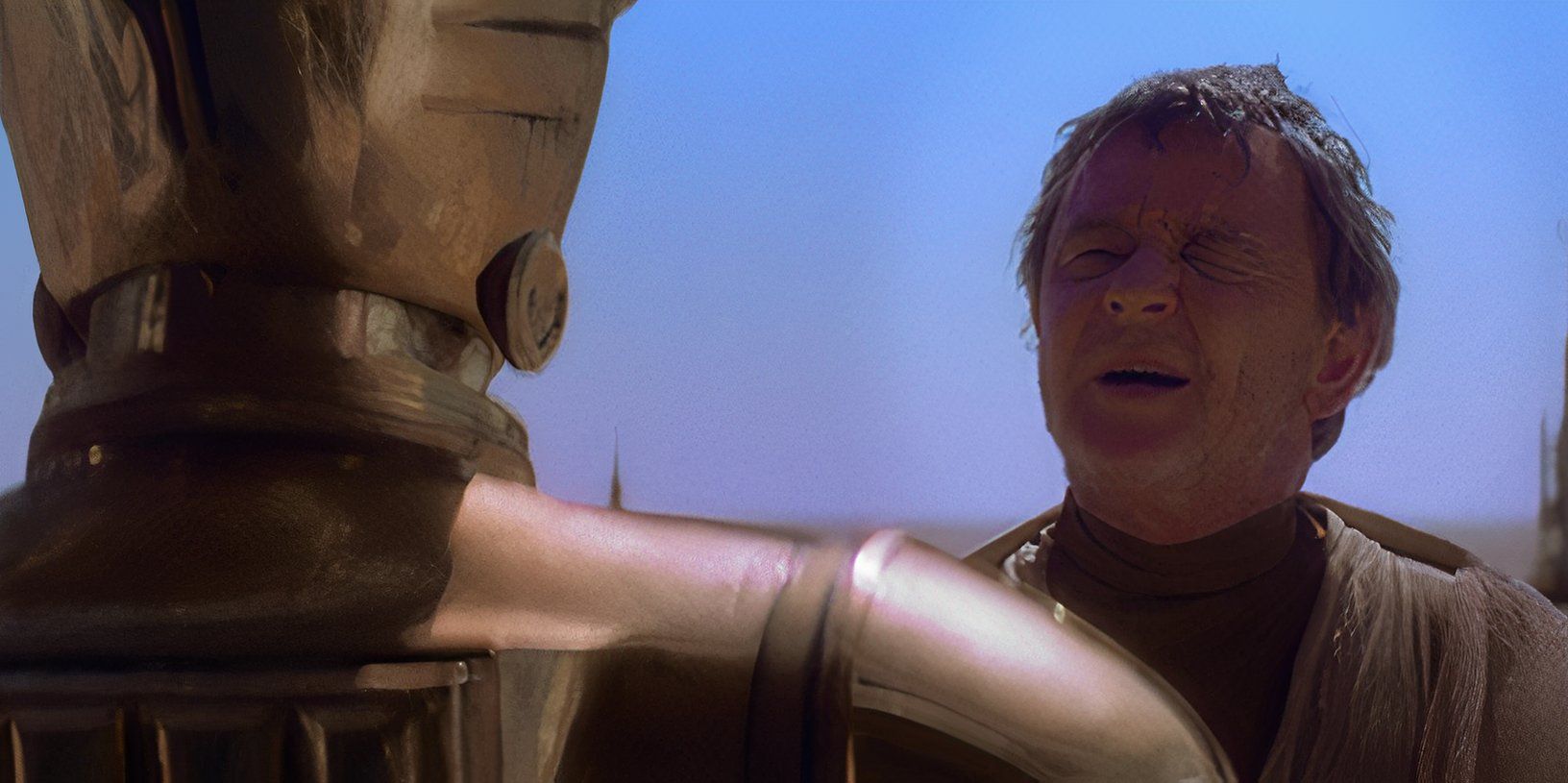 Uncle Owen talks to C-3PO in A New Hope