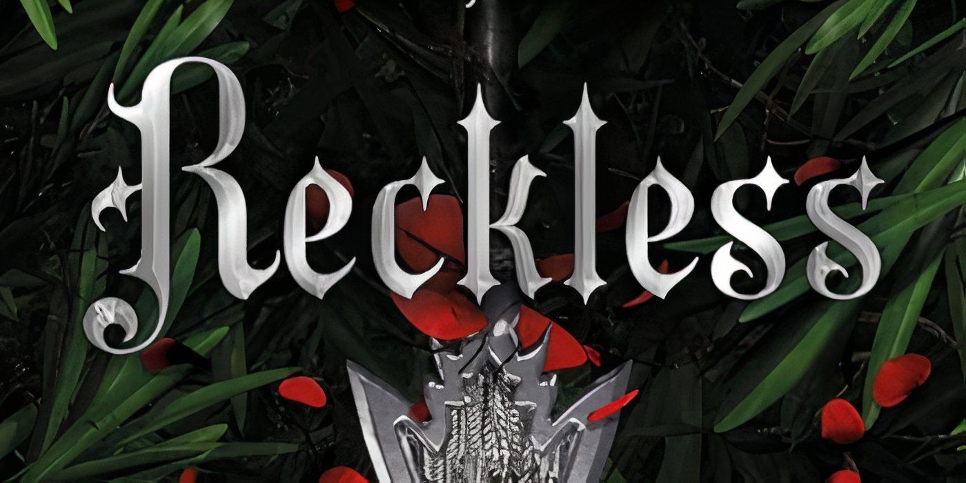The cover of Reckless by Lauren Roberts features the title in silver, a silver pendant, red flowers and green leaves