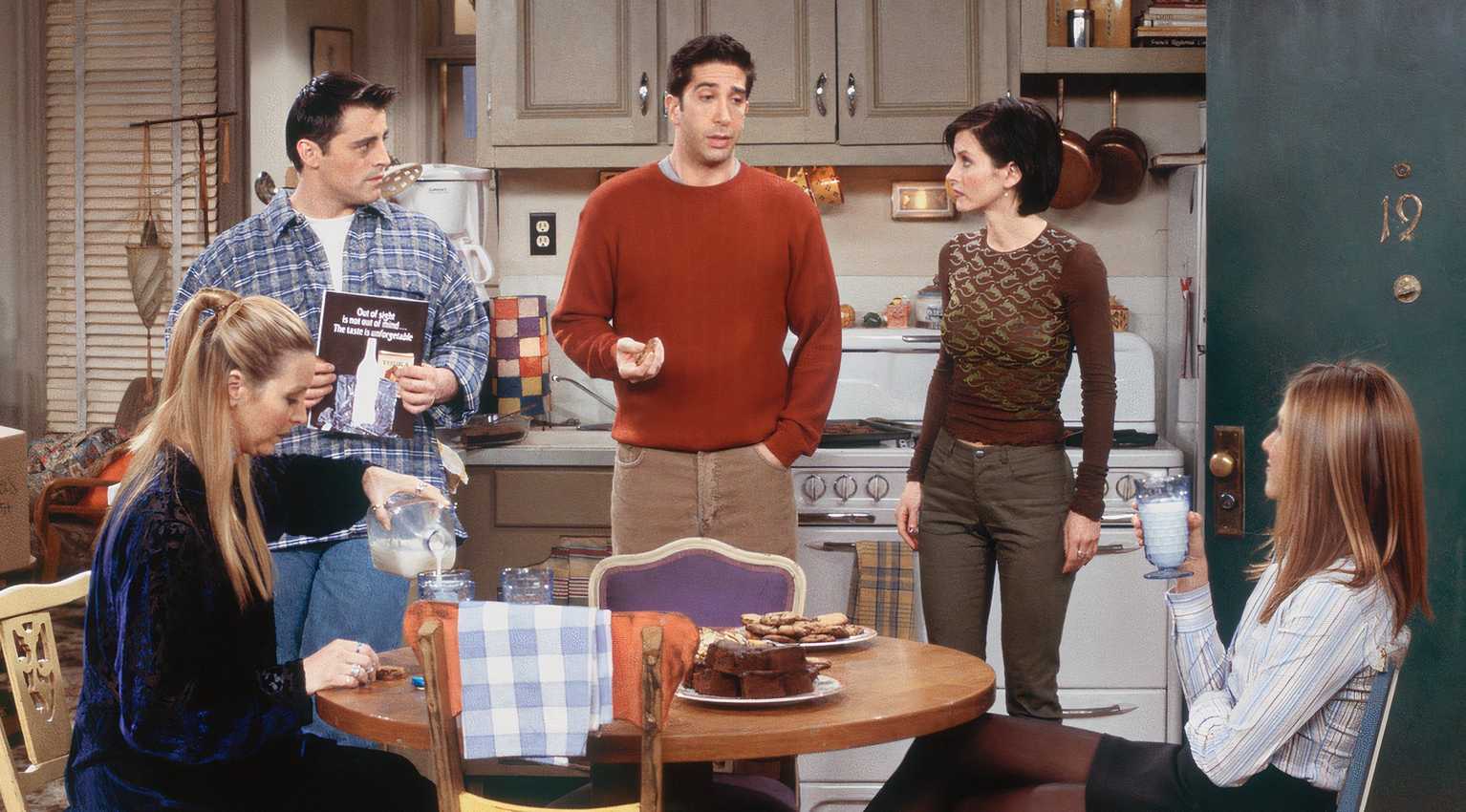 Ross talking in the apartment while Joey, Monica, and Rachel listen and Phoebe pours herself some milk in Friends