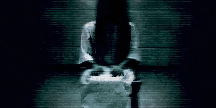 Samara sitting in the dark in a poor quality tape from The Ring