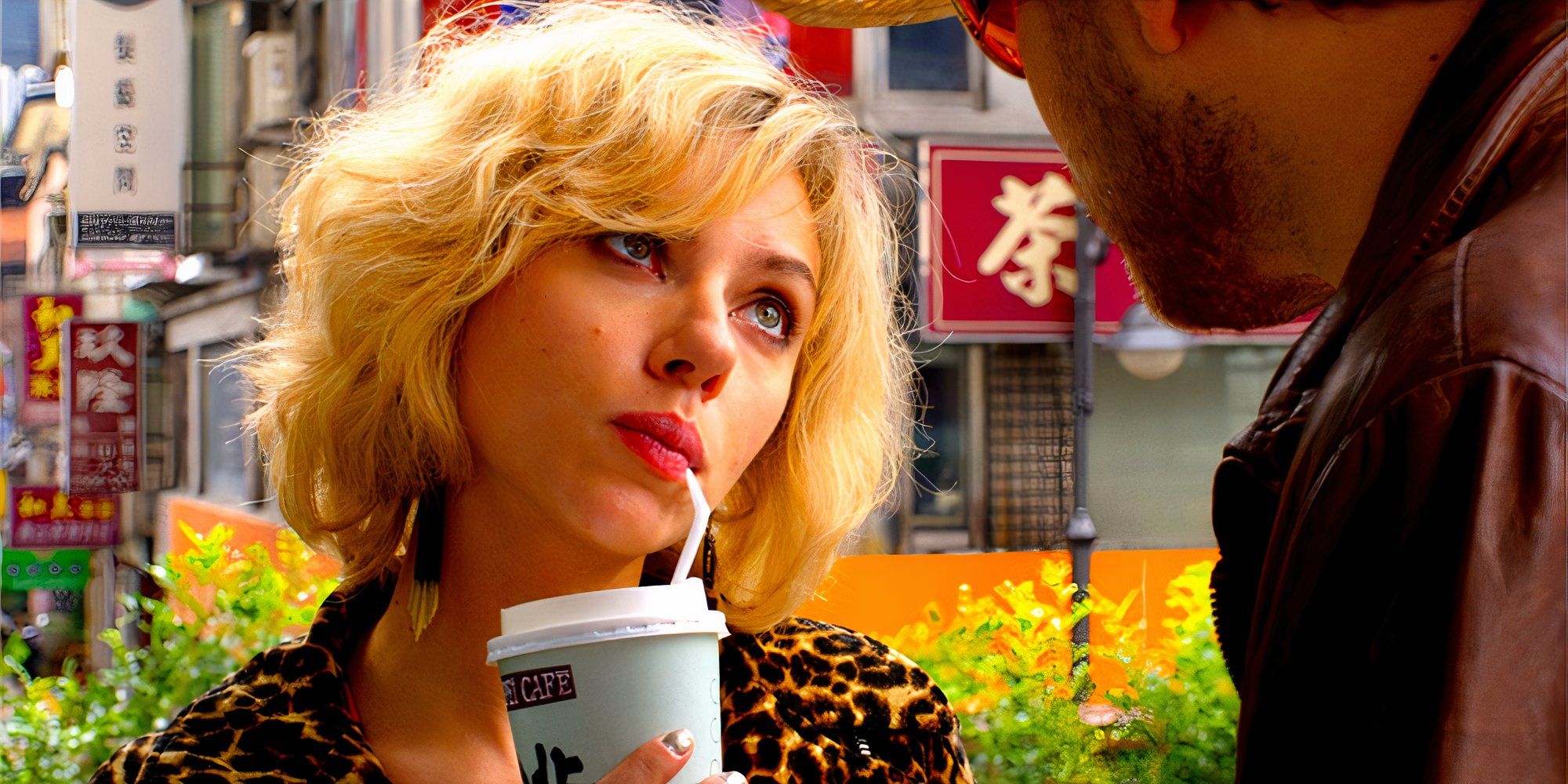 Scarlett Johansson as Lucy sipping a drink