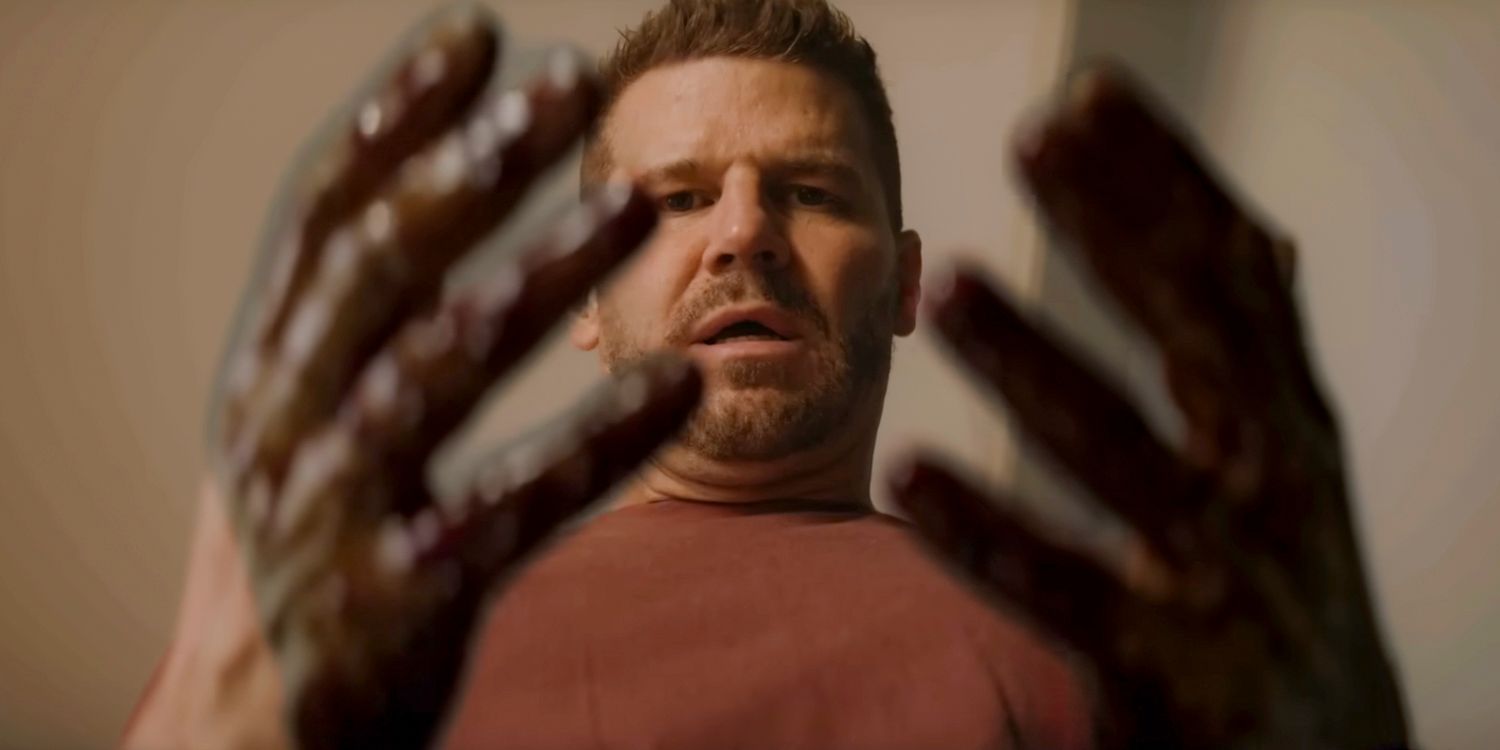 Jason (David Boreanaz) looking at his hands stained with blood in SEAL Team Season 7