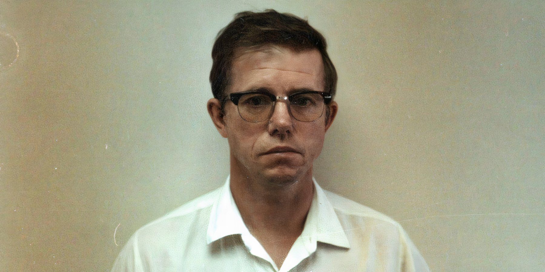 Serial killer Robert Hansen stares straight ahead against a white wall after his arrest