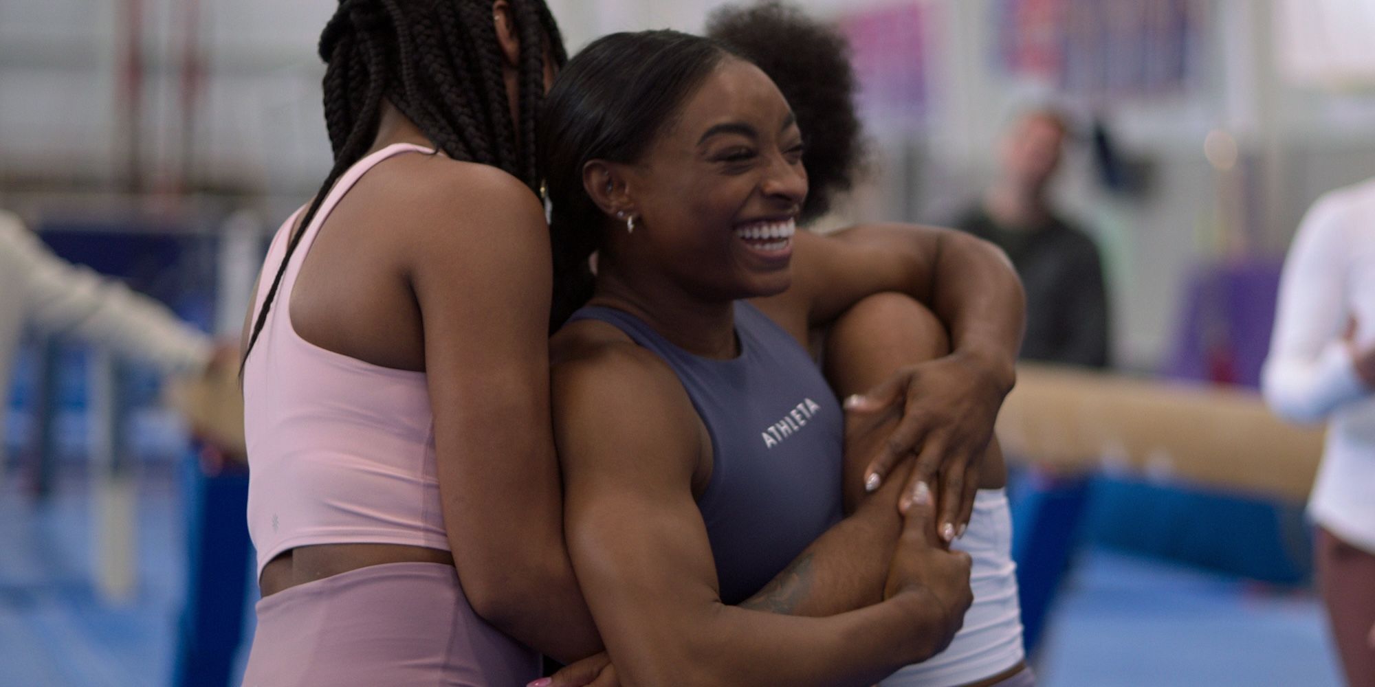 Simone Biles hugging other gymnasts in 2024 Netflix docuseries Simone Biles Rising.