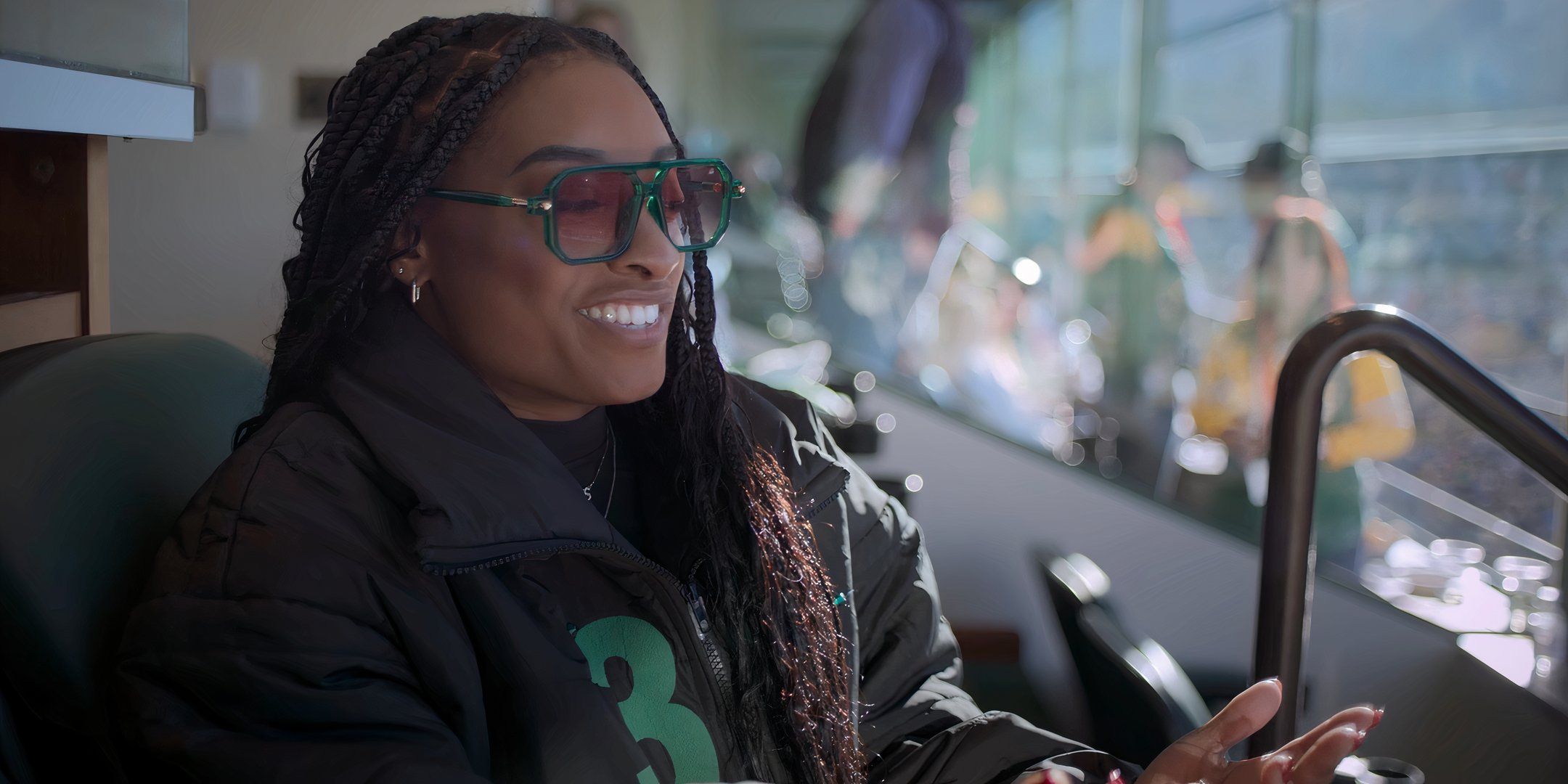 Simone Biles sits at a Green Bay Packers game. 