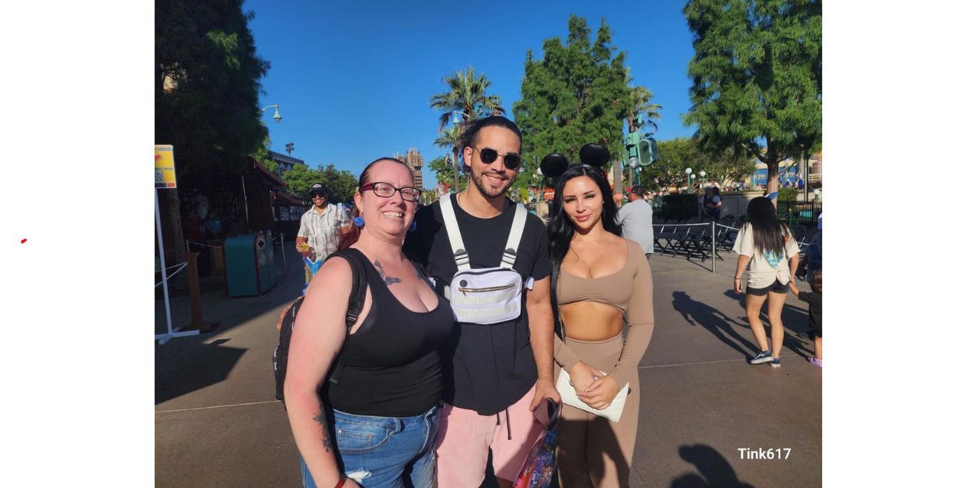 Sophie Sierra and Rob Warne on 90 Day Fiance posing with a fan at Disneyland on a date with Sophie dressed in brown co-ord set and Mickey Mouse ears and Rob in black t-shirt with fanny pack