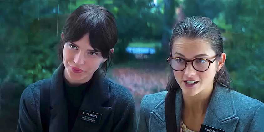 Sophie Thatcher's Sister Barnes and Chloe East's Sister Paxton stand in the rain in Heretic 2024 trailer