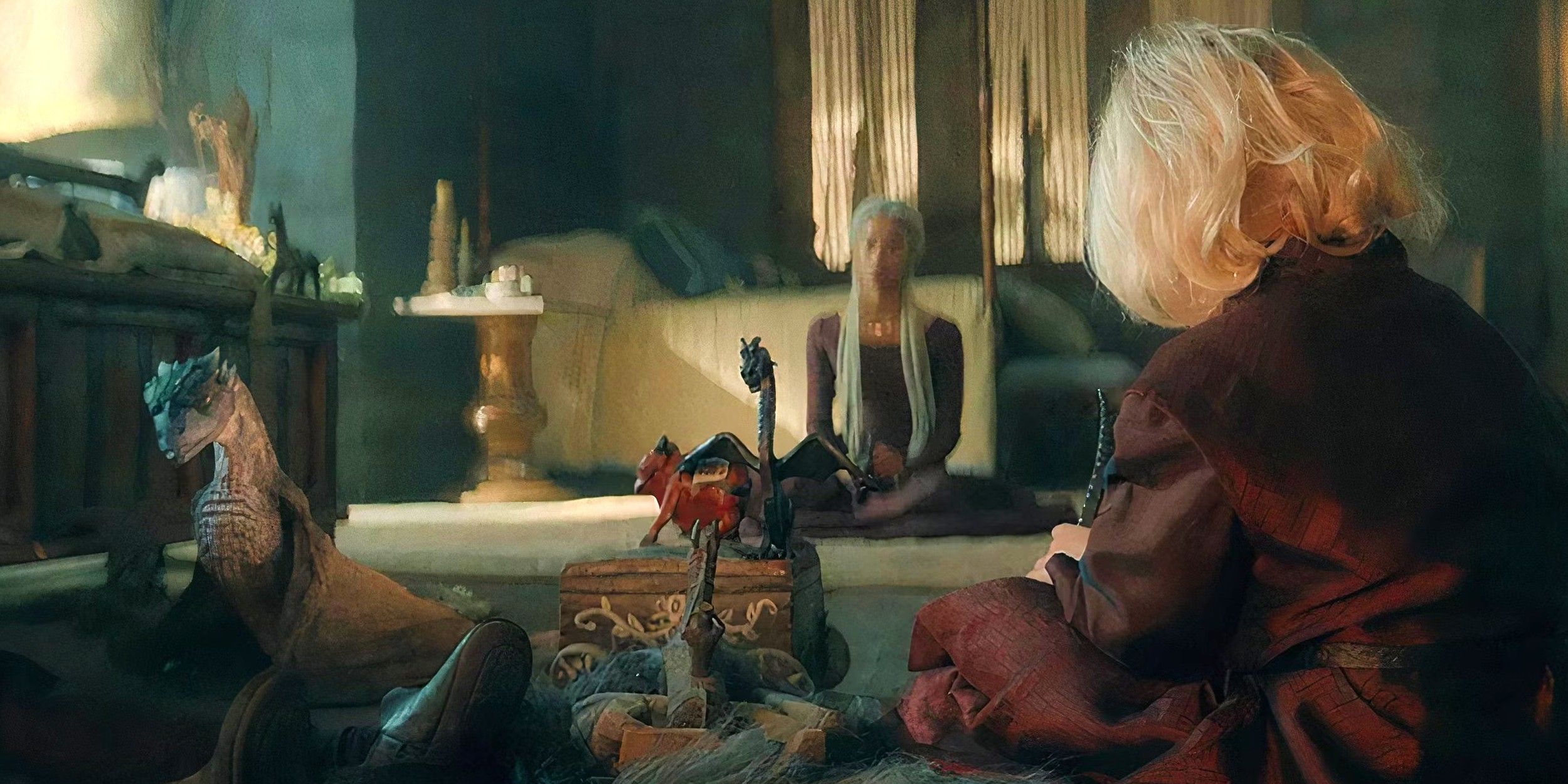 Stormcloud e Aegon, o Jovem Targaryen, sentados no chão brincando na 2ª temporada de House of the Dragon
