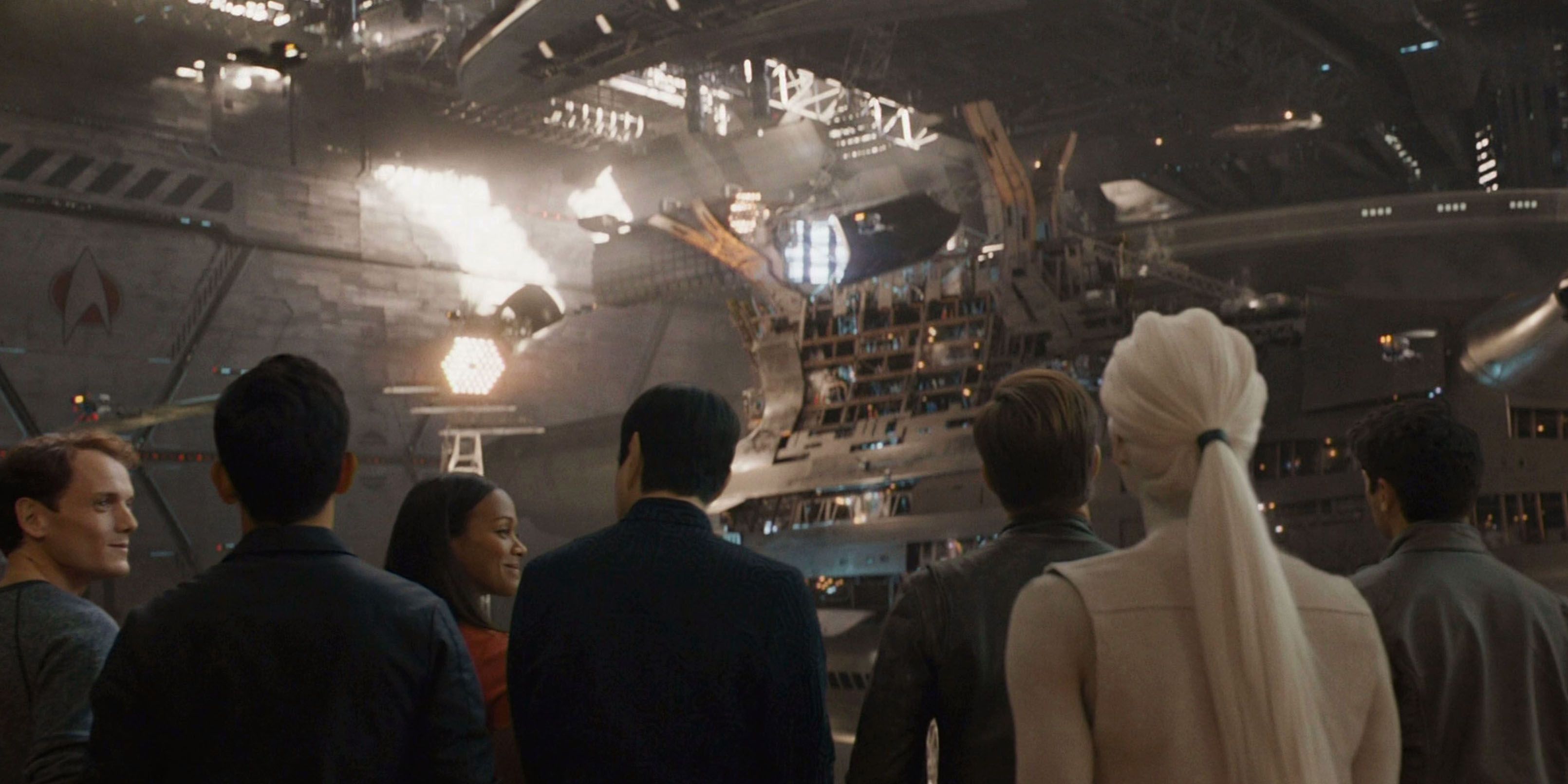 The crew in Star Trek Beyond including Jaylah watch the Enterprise-A being built